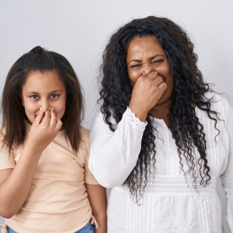 Mother,And,Young,Daughter,Standing,Over,White,Background,Smelling,Something