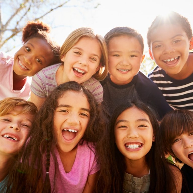 Multi-ethnic,Group,Of,Schoolchildren,On,School,Trip,,Smiling