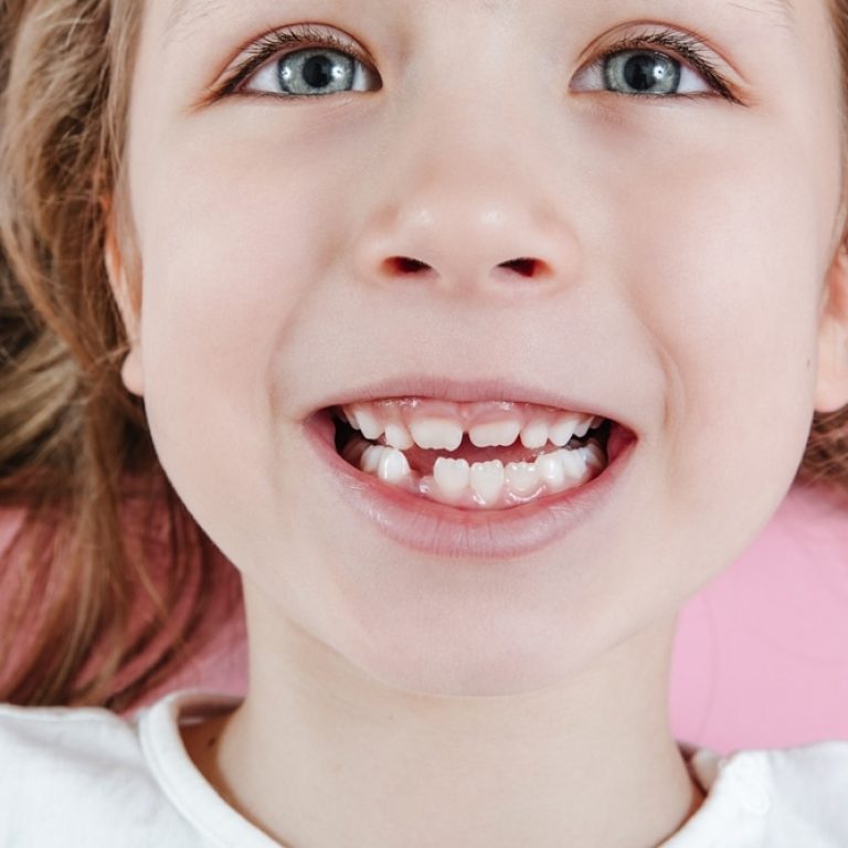 Happy,Smiling,Child,Portrait,On,The,Pink,Background.,Close-up,Of