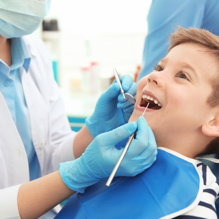 Dentist,Examining,Little,Boy's,Teeth,In,Clinic