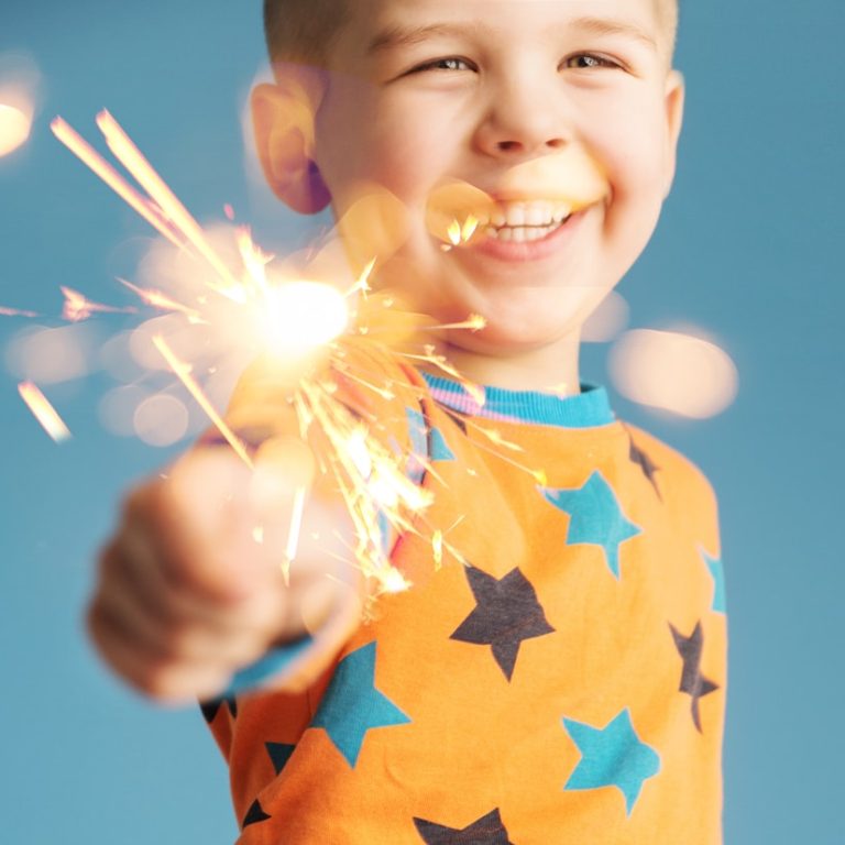 Smiling,Boy,Holding,Fireworks
