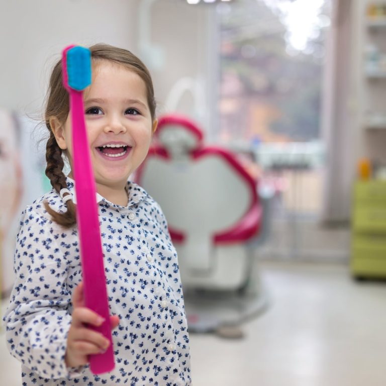 Lovely toddler visiting the dentist, having an examination.