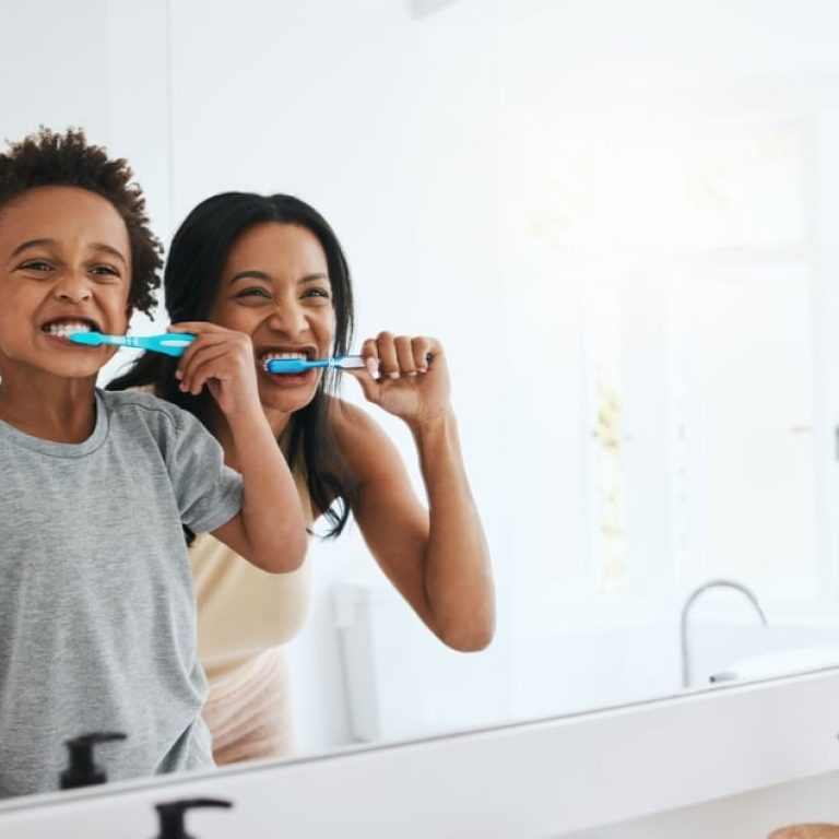 Learning,,Mother,And,Son,Brushing,Teeth,,Dental,Hygiene,And,Wellness