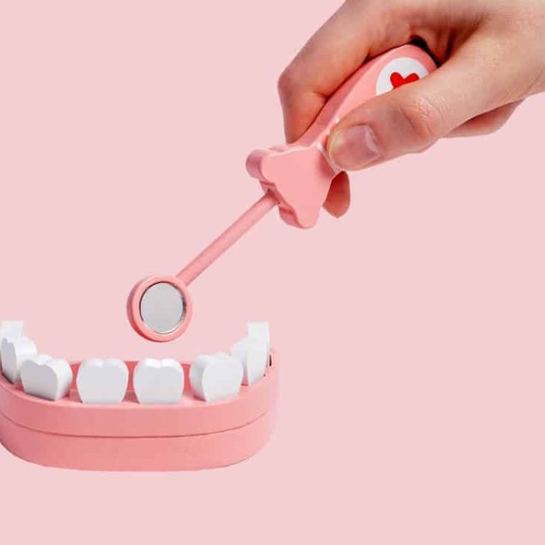 Hand,With,Dental,Mirror,Teeth,In,Jaw,Model,And,Exploring