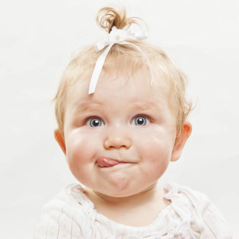 Portrait,Of,An,Adorable,Baby,Girl,With,Tongue,Sticking,Out