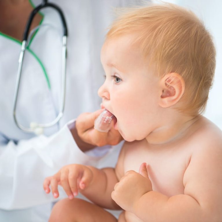 Doctor,Cleans,Baby,Teeth,With,A,Special,Brush