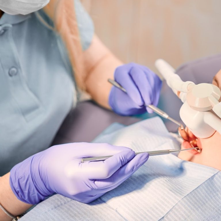 Female,Dentist,Checking,Child,Teeth,With,Dental,Explorer,And,Mirror